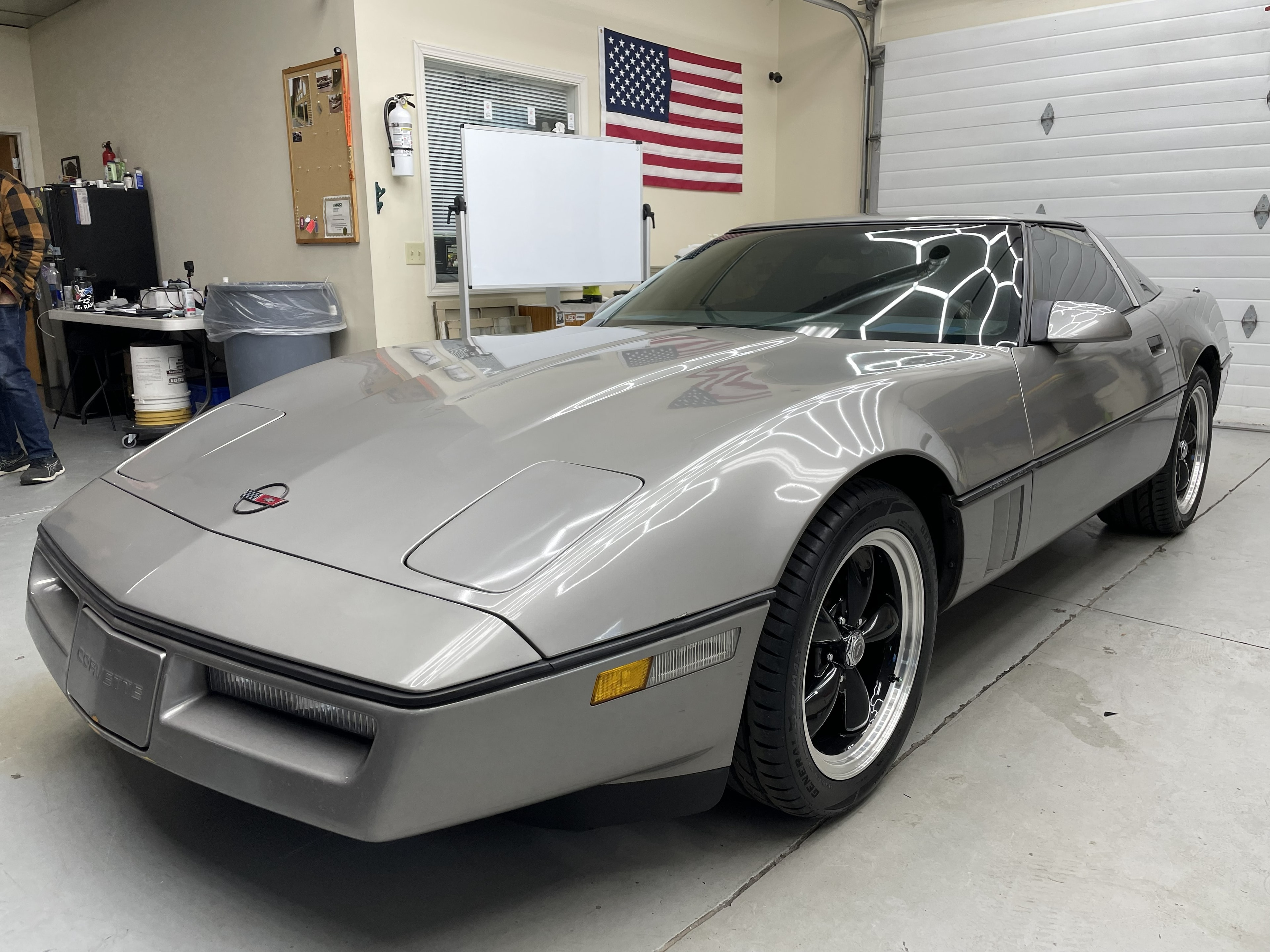 Silver Corvette in garage
