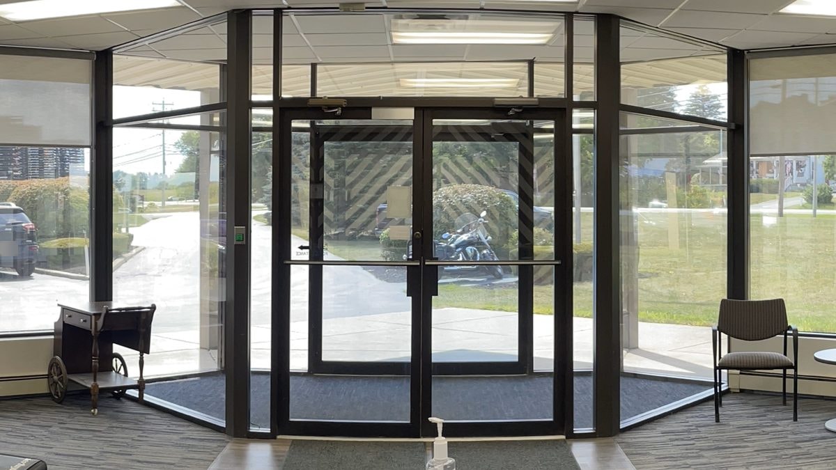 Floor-to-ceiling lobby windows with commercial window film in Rochester, NY