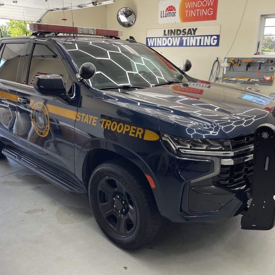 State Trooper Chevrolet Tahoe with tinted windows inside the Lindsay Window Tinting shop in Rochester, NY