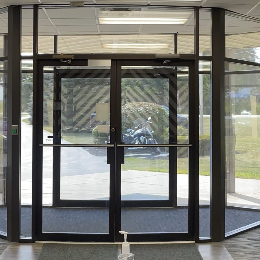 Tinted glass entry doors and windows in a commercial building lobby