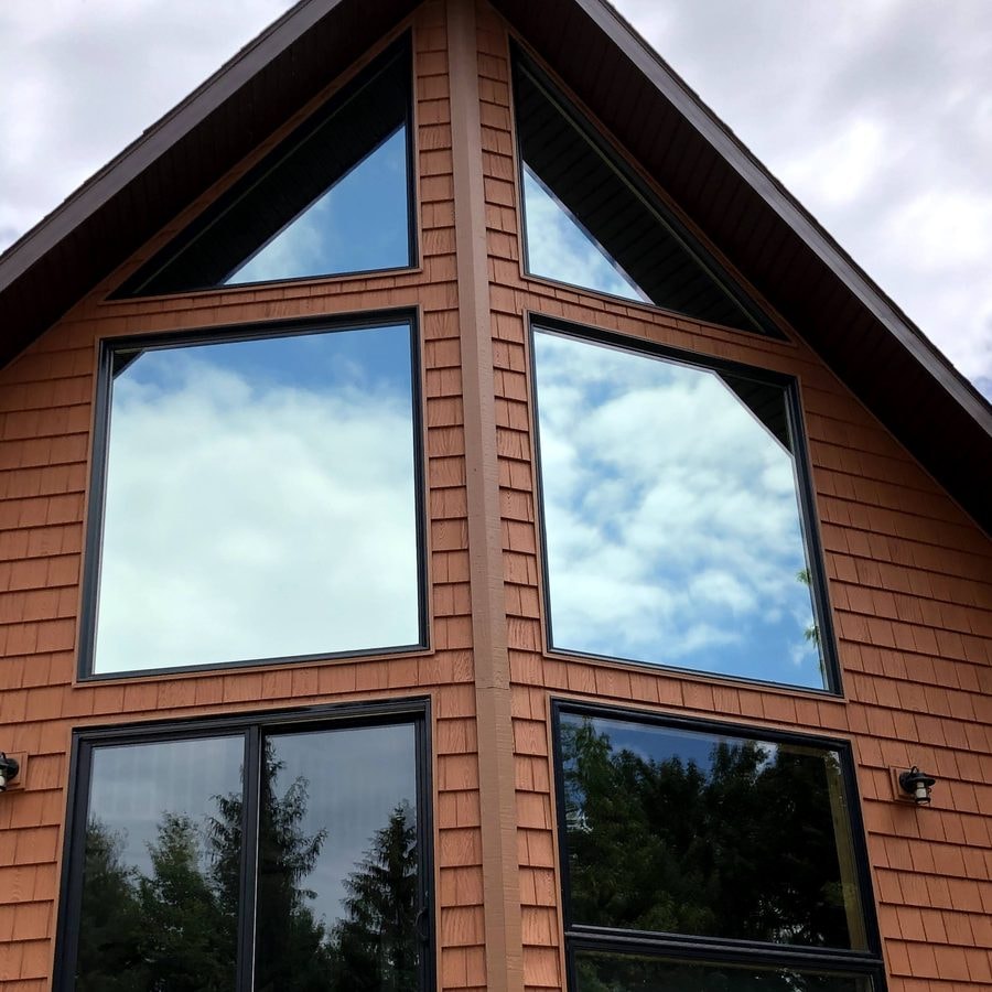 Tinted gable windows on a cedar-shingle home
